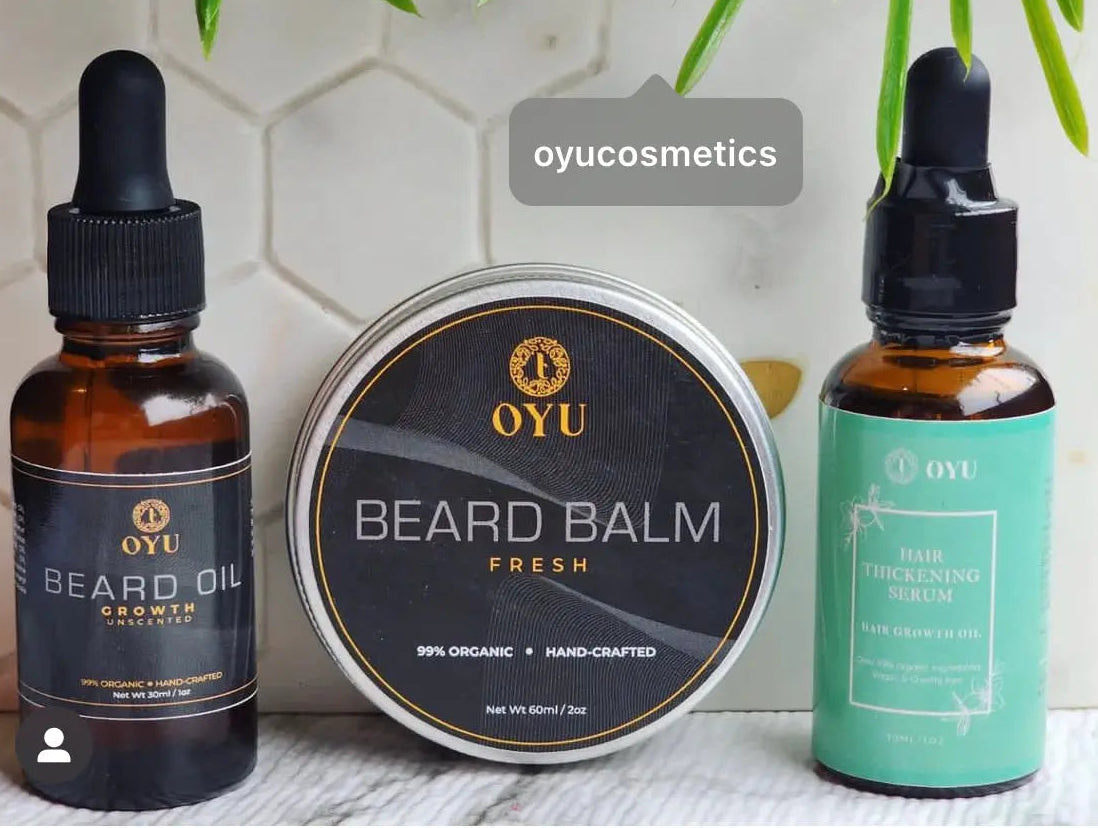 A stylishly arranged collection of beard and hair care products, including bottles of beard oil, shampoo, conditioner, and styling gel, displayed against a clean, modern background."